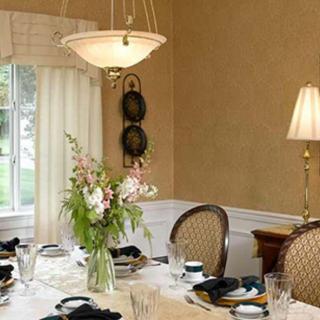 A beautifully set dining room with elegant decor, featuring a floral centerpiece and a stylish chandelier.