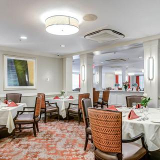 An elegantly designed dining room with neatly arranged tables and chairs.