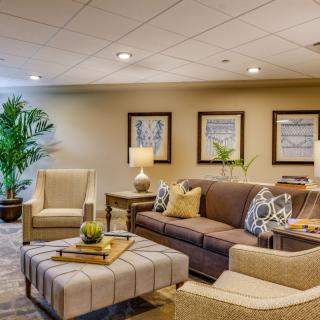 A cozy and well-decorated living room with comfortable seating and warm lighting.