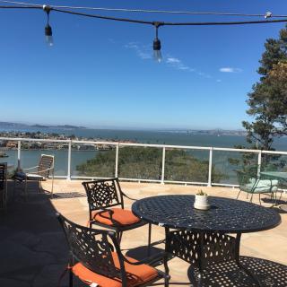 A scenic patio with outdoor seating offering a view of the ocean.