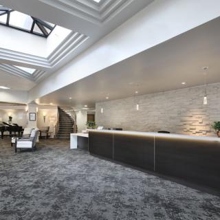 A modern lobby with a sleek reception desk and stylish decor.