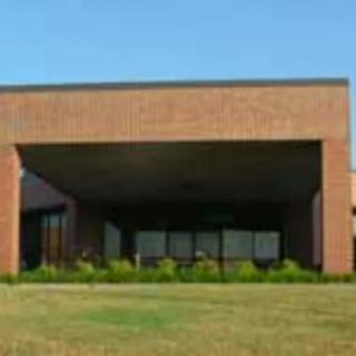 A brick building with a large covered entrance.