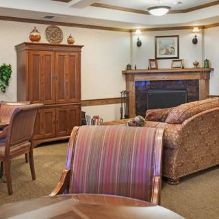 Cozy living room with wooden furniture and a fireplace.