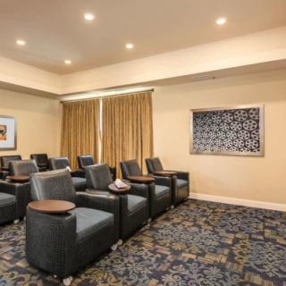 A small theater room with comfortable seating and a large screen.