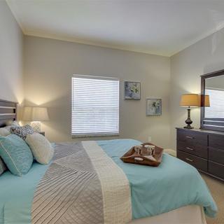A modern bedroom with stylish decor and comfortable bedding.