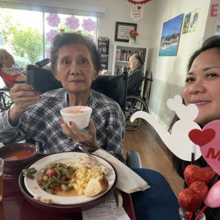 Two people enjoying a meal together indoors, suggesting a celebration.