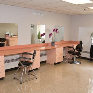 A well-organized beauty salon with multiple styling stations and mirrors.