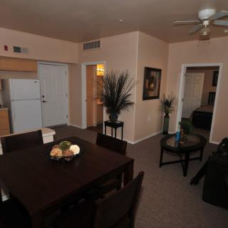 A cozy apartment with a combined living, dining, and kitchen area.