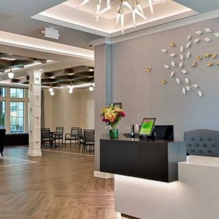 A modern reception area with elegant decor and lighting, featuring a welcoming lobby space.