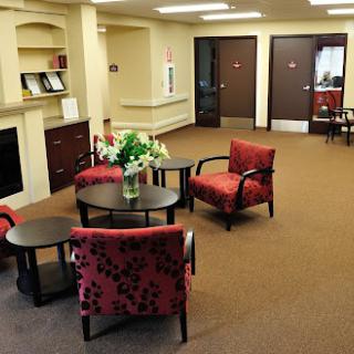 A cozy waiting area with comfortable chairs and a decorative table.