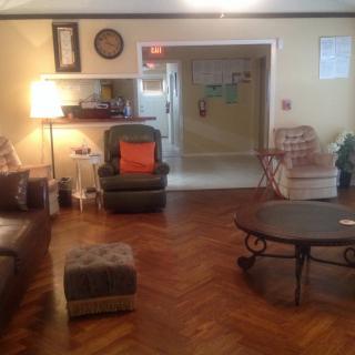 A cozy living room with various seating options and a coffee table.
