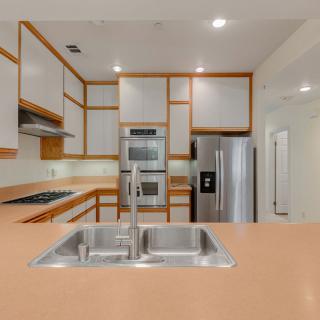 A modern kitchen featuring stainless steel appliances and warm wood accents.