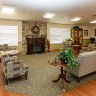 A cozy living room with comfortable seating and a fireplace.