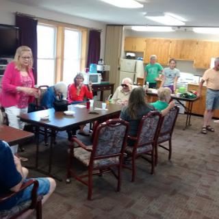 A lively social gathering in a community setting, with participants engaging in conversation and activities.