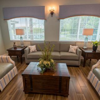 A cozy living room with a sofa set, coffee table, and ambient lighting.