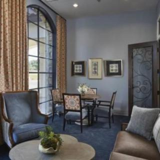 A stylish living room with elegant furniture and large windows.