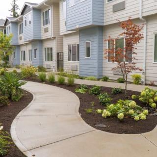 A well-maintained apartment complex with a landscaped pathway.