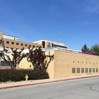 A modern brick building against a clear blue sky.
