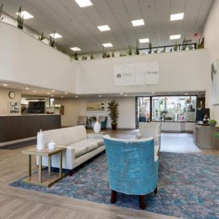 A spacious and modern lobby with comfortable seating and a reception desk.