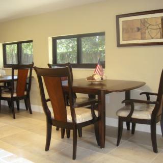 A cozy dining area with wooden furniture and natural light.