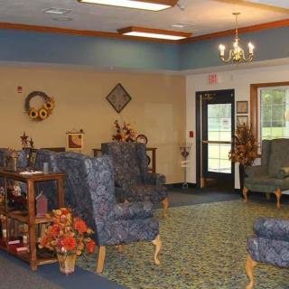 A cozy waiting area with comfortable chairs and decorative elements.