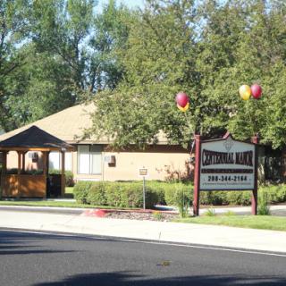 A welcoming residential building with a sign and decorative balloons.