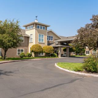 A well-maintained building with landscaped surroundings on a sunny day.