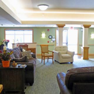 A cozy living room with comfortable seating and decorative elements.