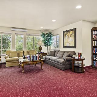 A cozy living room with comfortable seating and a large window view.