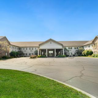 A well-maintained residential building with a welcoming entrance surrounded by lush greenery.