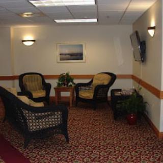 A cozy lobby area with wicker furniture and decorative elements.