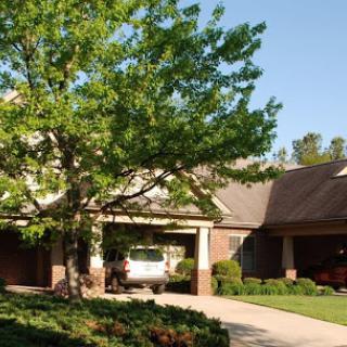 A picturesque residential home surrounded by lush greenery.