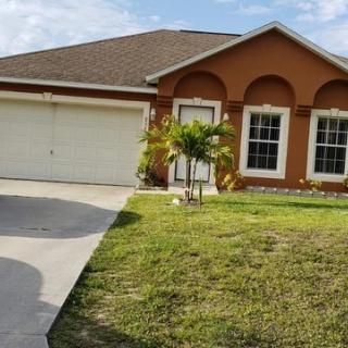 A suburban house with a lawn and garage.