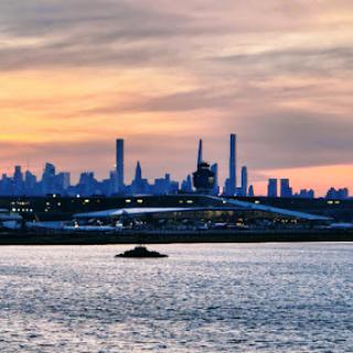 A stunning sunset view of a city skyline reflecting on the water.