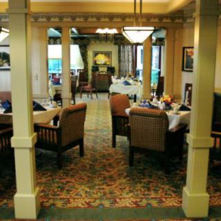 An interior view of a restaurant dining area with tables and chairs arranged neatly.