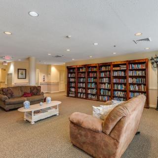 A cozy reading area with bookshelves and comfortable couches.