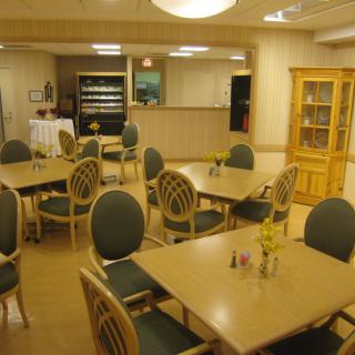 An empty dining area with neatly arranged tables and chairs.