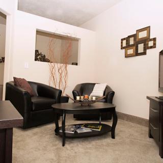 A modern living room with comfortable seating and stylish decor.