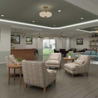 A modern lounge area featuring comfortable chairs, wood flooring, and elegant lighting.