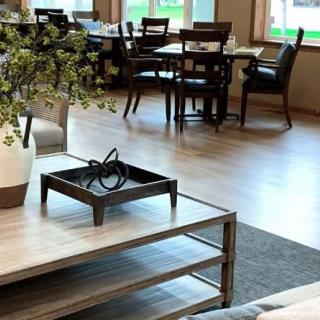 A modern cafe interior with tables, chairs, and decorative elements.