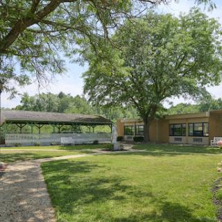 A serene outdoor space featuring lush greenery and a well-maintained garden area.
