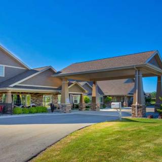 A well-maintained residential building with a covered entrance and manicured landscaping.
