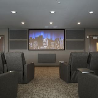 A cozy home theater with comfortable seating and a large screen.