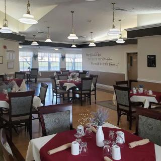 An elegantly set dining area with neatly arranged tables and chairs.