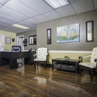 A well-organized office waiting room with comfortable seating and tasteful decor.