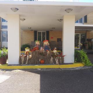 Welcoming autumn with festive scarecrow decorations at the entrance.