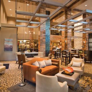 A spacious and elegantly designed hotel lobby with modern furniture and stylish lighting.
