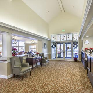 A spacious lobby with comfortable seating and natural lighting.