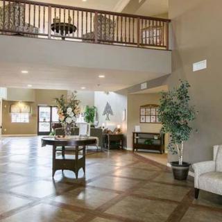 Spacious lobby area with elegant decor and a balcony overlooking the entrance.