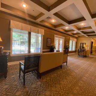 A spacious and elegantly designed lobby with comfortable seating, large windows, and soft lighting.